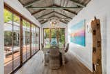 Dining room features vintage tongue-and-groove ceiling and LaCantina patio doors with Emtek hardware.