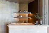 The island is completed by the use of both slatted and smooth dark stained oak cabinetry, bringing our three main materials together. 