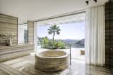 The showstopper in the space is the custom hand-carved round bath sculpted from a full block of marble in Italy. 