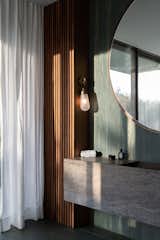 A Verde Picasso marble was used on all surfaces in the principle bathroom and reflects the house's forrest-rich surroundings.