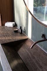 Bronze, sweetened Muschelkalk and Verde Picasso marble make up the material palette of the principle bathroom.