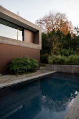 The facade was clad in Muschelkalk natural stone with panels of aluminum in bronze tones. So it was a first natural step for the studio to bring these materials seamlessly from outside to inside.  Photo 14 of 15 in AW House by Charlotte de Bruijn