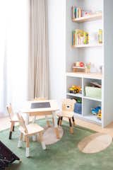 Kids Room, Light Hardwood Floor, Rug Floor, Shelves, Storage, Bookcase, Toddler Age, Boy Gender, Bedroom Room Type, Chair, and Desk Custom millwork with child-friendly cubby storage  Photo 2 of 4 in Gramercy Toddler's Room by Press Interiors