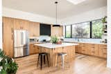 Kitchen, Engineered Quartz Counter, Light Hardwood Floor, Wood Cabinet, Undermount Sink, Recessed Lighting, Pendant Lighting, Range Hood, Refrigerator, Ceramic Tile Backsplashe, and Range  Photo 5 of 19 in Scandinavian Mid-Mod Ranch by Clark Thomas