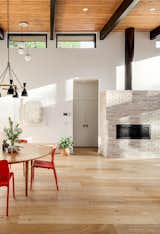 Dining Room, Chair, Pendant Lighting, Ceiling Lighting, Light Hardwood Floor, Table, Gas Burning Fireplace, and Recessed Lighting  Photo 6 of 19 in Scandinavian Mid-Mod Ranch by Clark Thomas