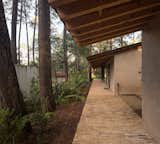 The house is connected by an outside porch / walkway made with brick.