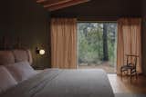 The master bedroom contrasts with a dark interior.