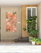The calligraphic fusion of 'ram ram ram' serves as the soulful heartbeat of the floral canvas artwork adorning the front wall of the porch. The rationale behind this thoughtful integration goes beyond aesthetic balance; it delves into a spiritual ideology, creating a nuanced connection between art and meaning. Positioned strategically, the artwork extends a warm and inviting greeting to visitors as they approach the residence. 