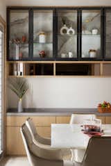 A connected balcony adds a delightful touch, offering picturesque views of lush greenery. This integration transforms the compact space into a perfect haven. Marked by a keen eye for detail and a subtle grey and white palette, the design achieves a harmonious balance between aesthetics and functionality. Meticulously arranged elements create an inviting atmosphere, establishing this zone as an ideal hub for culinary pursuits and shared meals.