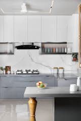 The kitchen and dining space epitomize thoughtful design, seamlessly blending activities for an efficient flow. Starting with a hygienic wash area at the south end, the kitchen features a clever serving counter, creating a practical cooking zone. The dining table is accompanied by an elegant crockery unit and a nearby store room, optimizing functionality. 