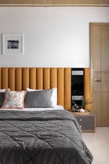 Son's Bedroom: With a singular focus on minimalism, the son's bedroom embodies simplicity and sophistication. The walls and ceiling, adorned in shades of grey, create a serene and calming backdrop that sets the stage for a tranquil atmosphere. Adding a subtle touch of warmth and personality, a muted orange bed-back becomes the focal point of the room. This carefully chosen accent introduces a gentle pop of color, breaking the monotony of the greyscale palette and infusing the space with a sense of vibrancy. The deliberate decision to keep the son's bedroom minimal reflects a thoughtful approach to design, allowing for a clean and uncluttered environment. This space not only prioritizes simplicity but also captures a harmonious balance between understated elegance and a personalized touch, creating a retreat that is both calming and uniquely individual. 