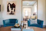 The blue ceilings were inspired by my southern Louisiana roots. The alpaca tapestry was from a neighbor's estate sale. Cheap amazon velvet swivel chairs, a ceramic elephant that has been in my family my whole life, and a splurgy coffee table pull the look together.