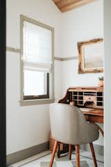 A woman's antique writing desk from an antique store in Laramie fit just right in the entry to create a workspace. 