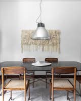 Dining Room, Table, Medium Hardwood Floor, Pendant Lighting, and Chair An closer view shows the wall tapestry made on the loom by artist Bruna Octaviano.  Photo 2 of 24 in Apartment on a building from 1948 in São Paulo. by Lia Soares Arquitetura
