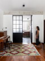Doors, Interior, Metal, and Sliding Door Type The sliding door separates and integrates the kitchen and living room.  Photo 3 of 24 in Apartment on a building from 1948 in São Paulo. by Lia Soares Arquitetura