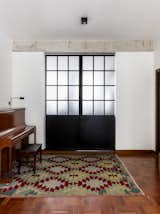 Doors, Interior, Metal, and Sliding Door Type The piano was a gift to both kids.  Photo 4 of 24 in Apartment on a building from 1948 in São Paulo. by Lia Soares Arquitetura