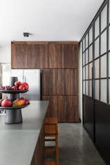 Kitchen, Wood Cabinet, Slate Floor, Microwave, Ceiling Lighting, Wood Counter, Wall Oven, Cooktops, Drop In Sink, Refrigerator, and Dishwasher Kitchen cabinets made with demolition wood.  Photo 5 of 24 in Apartment on a building from 1948 in São Paulo. by Lia Soares Arquitetura