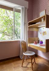 Bedroom, Chair, Pendant Lighting, Bench, Storage, and Medium Hardwood Floor This desk was designed for each of the children. It was screwed to the wall at different heights as the children grew.  Photo 17 of 24 in Apartment on a building from 1948 in São Paulo. by Lia Soares Arquitetura