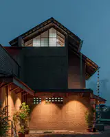 The wooden fascia in the  overhangs and  highlighting  the exposed brick wall texture 