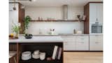 Kitchen countertops feature Caesarstone Quartz & Miele appliances.