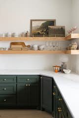 Another view of kitchen showing the custom open shelving. We wanted both open shelving to show off found art and locally sourced ceramic dishware and enough cabinetry to hide away cookware as well as groceries.