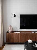 Living Room, Ceiling Lighting, Light Hardwood Floor, Chair, Sofa, Console Tables, and Floor Lighting Custom made TV stand of solid walnut wood slats and walnut veneer. Sconce lamp, Rubn.  Photo 8 of 11 in New Life of a 80 m2 Moscow Apartment by Static Aesthetic Architects by Static Aesthetic Architects