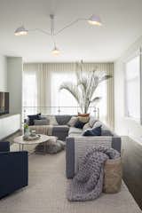 Living Room, Pendant Lighting, Sofa, Chair, Rug Floor, Coffee Tables, Sectional, and Dark Hardwood Floor  Photo 3 of 10 in Bucktown Project by Real Talk Interiors