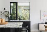 Kitchen, Marble Counter, Marble Backsplashe, Wood Cabinet, Wall Lighting, Drop In Sink, and Concrete Floor Kitchen  Photo 5 of 10 in McNeill House by ARYZE Developments Inc.