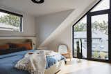 Bedroom, Chair, Night Stands, Ceiling Lighting, Light Hardwood Floor, and Bed Bedroom  Photo 10 of 10 in McNeill House by ARYZE Developments Inc.