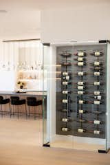 Kitchen, Ceiling Lighting, Accent Lighting, Wine Cooler, Stone Counter, and Wood Cabinet Custom-enclosed wine wall with a Venetian plaster back finish.  Photo 7 of 19 in Hollywood Hills Remodel by Belyn Studio
