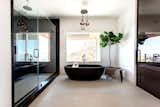 Concrete Floor, Enclosed Shower, Recessed Lighting, Stone Slab Wall, Pendant Lighting, and Freestanding Tub Master Bathroom remodel. Black bathtub, concrete tiles, and black Caesarstone for the shower.  Photo 10 of 19 in Hollywood Hills Remodel by Belyn Studio