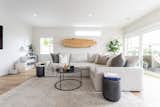 Living Room, Vinyl Floor, Coffee Tables, Rug Floor, Bookcase, End Tables, Storage, Ceiling Lighting, Sectional, and Sofa Living room  Photo 17 of 23 in Pacific Beach House by Belyn Studio
