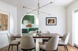 Dining room with arched opening into kitchen