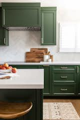 Kitchen, Range Hood, Engineered Quartz Counter, Cooktops, Medium Hardwood Floor, Colorful Cabinet, Subway Tile Backsplashe, and Recessed Lighting Kitchen detail shot with induction cooktop  Photo 9 of 12 in Cheerful Charmer by Studio Connolly