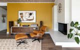 Living Room, Console Tables, Table Lighting, Ottomans, Chair, Dark Hardwood Floor, and Standard Layout Fireplace Den accent wall  Photo 3 of 13 in Midcentury Retro Revival by Studio Connolly