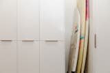 Custom white ash millwork; surfboard closet.