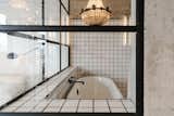 En suite spa bath; porcelain claw-foot tub with heritage Hudsons' Bay chandelier