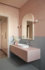 Elevated the space with French Clair & Clair Aqua full-body tiles from Johnson with groove details creating a geometrical composition, paired seamlessly with fittings from Jaquar and sanitaryware from Aquant.