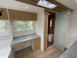 Bath Room, Enclosed Shower, Ceiling Lighting, One Piece Toilet, and Light Hardwood Floor Ombraz Tiny Home work station and Scandanavian Cedar washroom  Photo 1 of 7 in The Ombraz Tiny Home by andrea hope