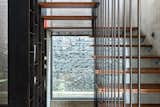 Staircase The compound wall, uses locally sourced stone as cladding and in gabion form, shielding the abode from the clamour of the bustling street  Photo 13 of 28 in The Annexe at Anand by INI Design Studio