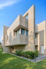 The beige and white sandstone and concrete exterior, complements the minimalist design