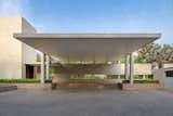 The expansive entrance driveway is covered by a sweeping canopy