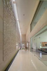The starkness of the linear double-height passage is artfully interrupted by interesting murals, adding artistic flair
