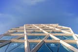 A double skin ceramic fritter high performance glazing system within the dia-grid with an interstitial air-cavity insulates the inner spaces