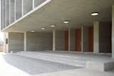 Celebrating the innate beauty of exposed concrete, the building intertwines material honesty with structural integrity