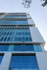 Double layer high performance glazing looped in a metallic panel clad frame