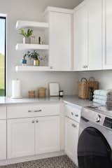 Fresh and spacious laundry room with ample storage and natural lighting. 