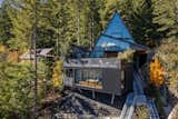 The home's main entrance is accessed via a tram-funicular system, or an extensive galvanized steel stairway.  Photo 1 of 10 in Alpine A-Frame by Marie-Joelle Marceau