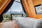 Bedroom, Medium Hardwood Floor, and Bed The primary bedroom.  Photo 8 of 10 in Alpine A-Frame by Marie-Joelle Marceau