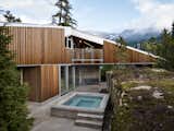 A secluded hot tub abuts the natural rock scape ensuring privacy for post slope decompressing.